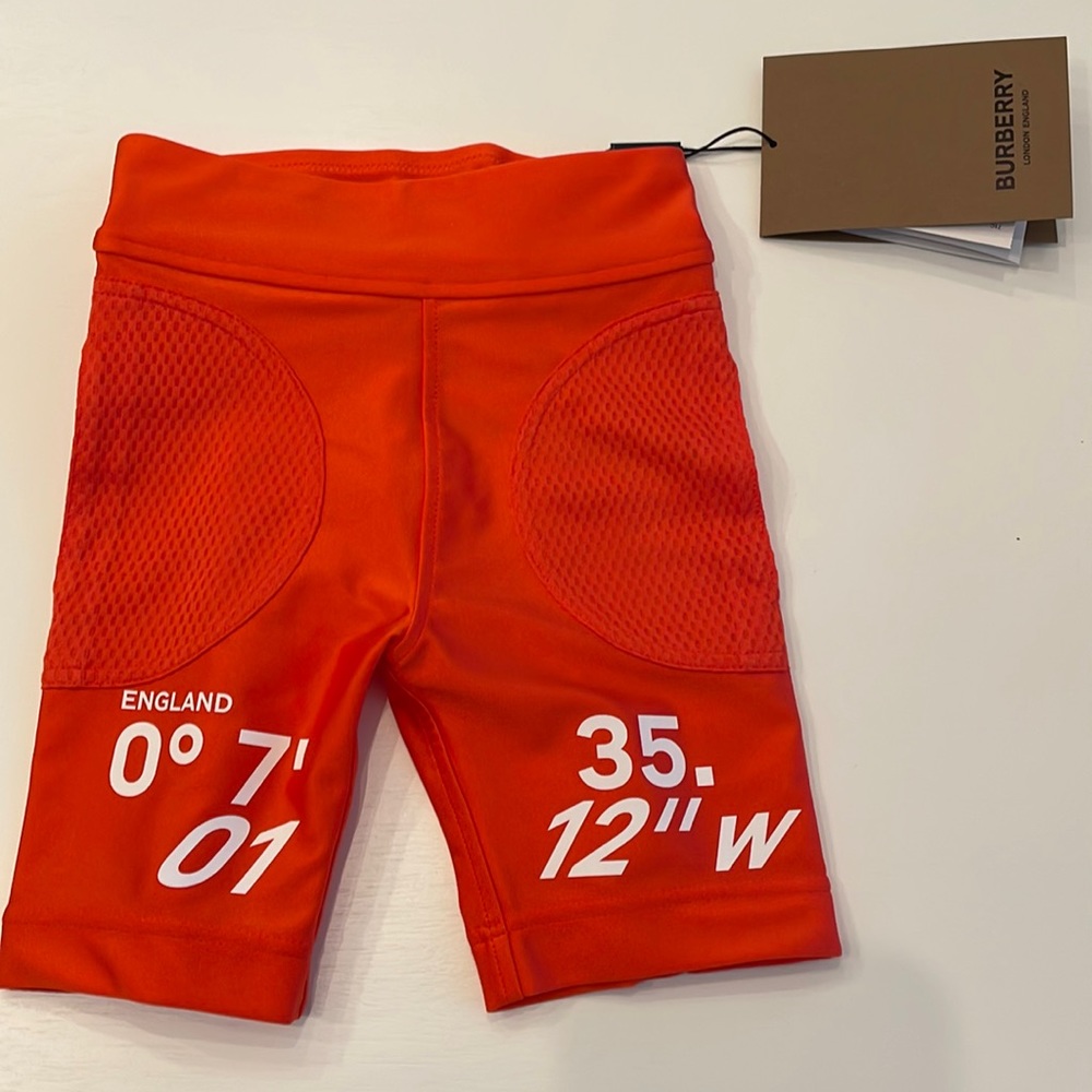 Burberry NWT toddler girl size 4 deep orange logo stretch “cycling” bike shorts.